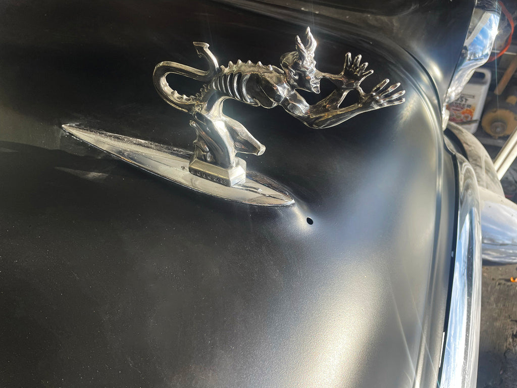 Solid pewter Speed Demon hood ornament showcasing detailed sculpting and flowing lines