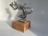 Close-up of handcrafted Speed Demon hood ornament with intricate facial and body details